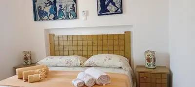 a bedroom with a bed with towels on it at Farfalla in Vila do Maio
