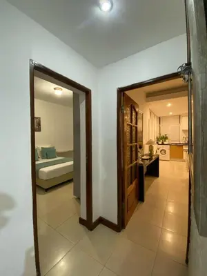 a hallway with a mirror and a room with a bedroom at Residence Fazenda - Piscina in Praia