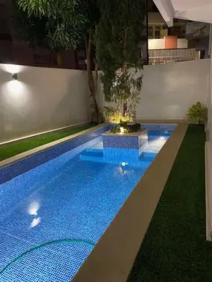 a large swimming pool with a tree in the middle at Residence Fazenda - Piscina in Praia