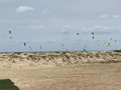 a bunch of kites flying over a sandy beach at MORADIAS I02/C in Prainha