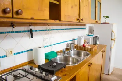 a kitchen with a sink and a stove top oven at Relaxing Blue Flat near beach! in Calheta Do Maio