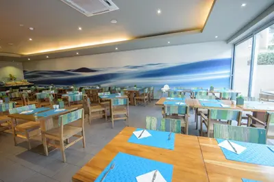 a dining room with wooden tables and chairs at Oasis Salinas Sea in Santa Maria