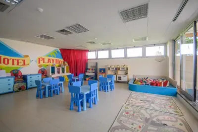 a classroom with blue tables and blue chairs at Oasis Salinas Sea in Santa Maria