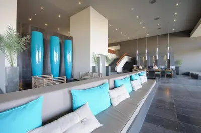 a row of blue pillows on a bench in a lobby at Oasis Salinas Sea in Santa Maria