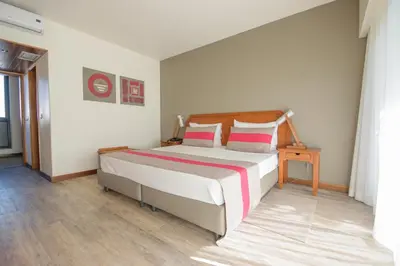 a bedroom with a large bed with two pillows at Oasis Belorizonte in Santa Maria