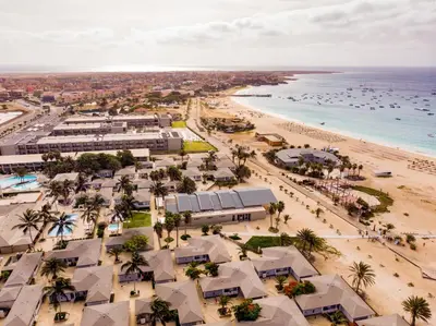 an aerial view of a beach with palm trees and buildings at Oasis Belorizonte in Santa Maria