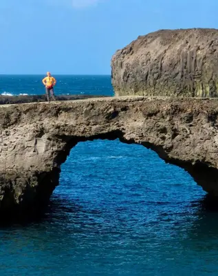 a man standing on a cliff over the ocean at Rose silva in Portela