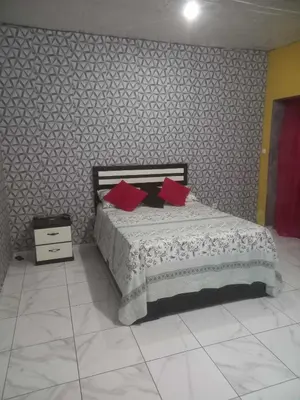 a bedroom with a bed with red pillows on it at Rose silva in Portela