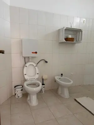 a bathroom with a toilet and a bidet at Tarrafal Ecodécor Rooms in Tarrafal