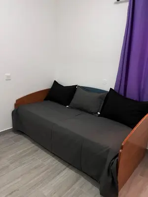 a bed in a room with a purple curtain at Casa Mar e Sol - Murdeira - Ilha do Sal in Palha Verde