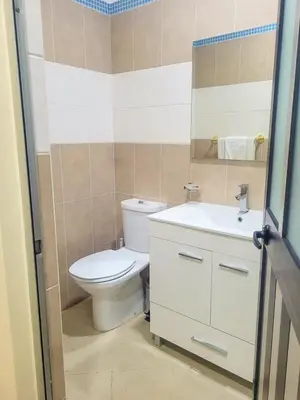 a bathroom with a toilet and a sink at Castelinho Sal Lodge in Espargos