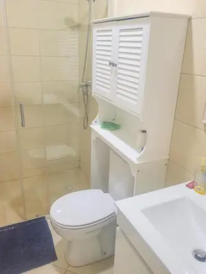 a white bathroom with a toilet and a shower at Castelinho Sal Lodge in Espargos