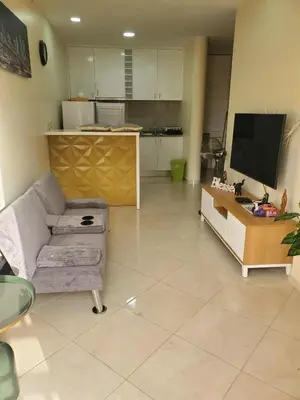 a living room with a couch and a tv at Castelinho Sal Lodge in Espargos