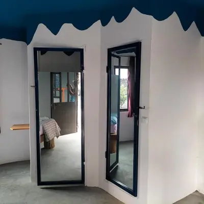 two mirrors on a wall in a room at Pensao Zé Doce in Portela