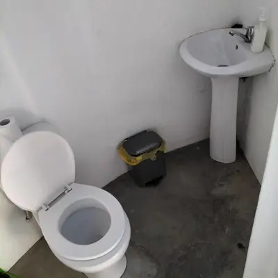 a bathroom with a toilet and a sink at Pensao Zé Doce in Portela