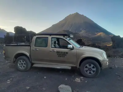 a truck parked in front of a mountain at Pensao Zé Doce in Portela