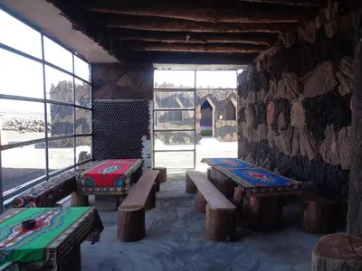 a room with benches and a wall with windows at Pensao Zé Doce in Portela
