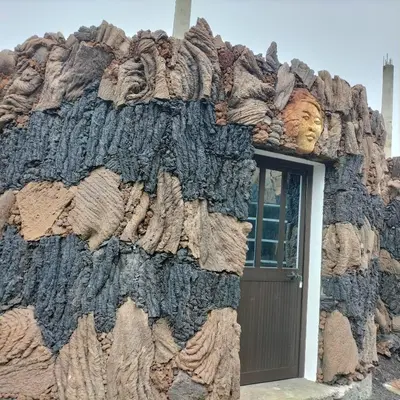 a building with a face on the side of it at Pensao Zé Doce in Portela