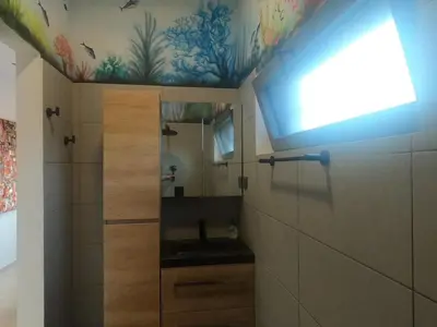 a bathroom with a sink and a mirror at Vila Babosa in Porto Novo
