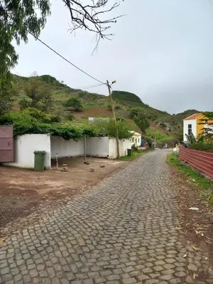 a cobblestone street with a hill in the background at Recanto da Montanha in Rui Vaz