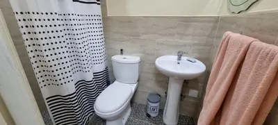 a bathroom with a white toilet and a sink at Recanto da Montanha in Rui Vaz