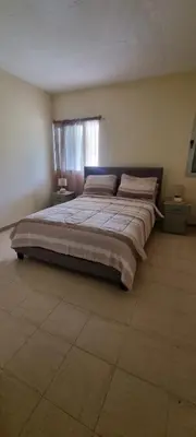 a large bed in a bedroom with a window at Recanto da Montanha in Rui Vaz