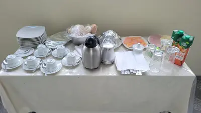 a table with plates and cups and dishes on it at Recanto da Montanha in Rui Vaz