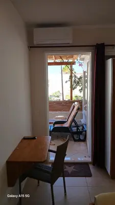 a living room with a table and chairs on a porch at Beach Villa am Praia de Chaves, Boa Vista, Cabo Verde in Boa Ventura