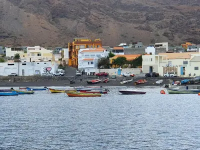 a group of boats in the water near a town at Seaview Apartment in Tarrafal