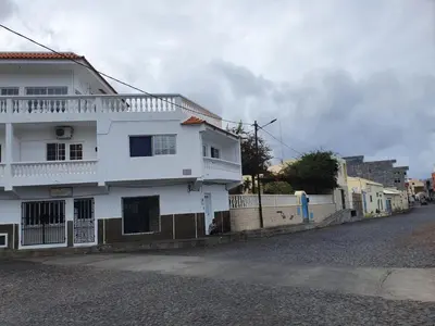 a white house on the side of a street at Seaview Apartment in Tarrafal