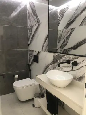 a bathroom with a sink and a toilet at Apartamento Deluxe Santa Filomena in Mindelo