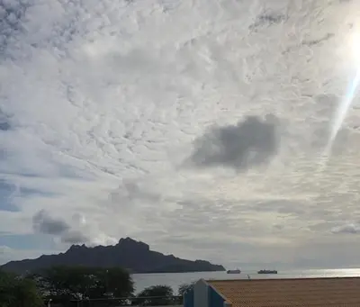 a cloudy sky with a mountain in the background at Apartamento Deluxe Santa Filomena in Mindelo