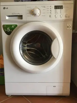 a white washing machine with its door open at Porto Antigo 2 Beach Club in Santa Maria