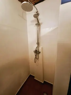 a shower in the corner of a room at Casa Praia Tarrafal de Monte Trigo in Seladinha