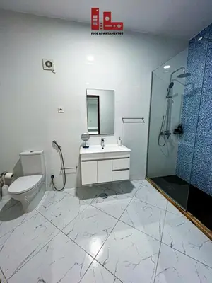 a bathroom with a toilet and a sink and a shower at Figo Apartamento Sol & Brisa Cidadela T2 in Praia