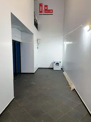 an empty room with a washer and a washing machine at Figo Apartamento Sol & Brisa Cidadela T2 in Praia