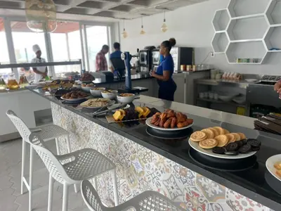 a kitchen with a counter with plates of food at Ouril Mindelo in Mindelo