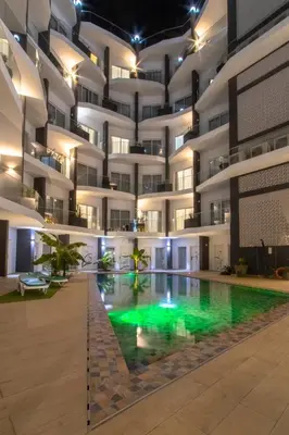 an apartment building with a pool in the middle at Ouril Mindelo in Mindelo