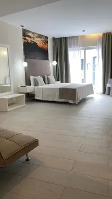 a large bedroom with a bed and a large window at Ouril Mindelo in Mindelo