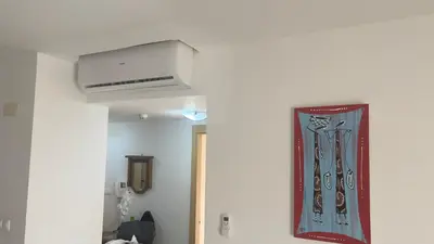 a room with a ceiling fan and a painting on the wall at Apartamento T2 equipado Vila Verde in Santa Maria