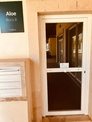 a door with a sign on the side of a building at Apartamento T2 equipado Vila Verde in Santa Maria