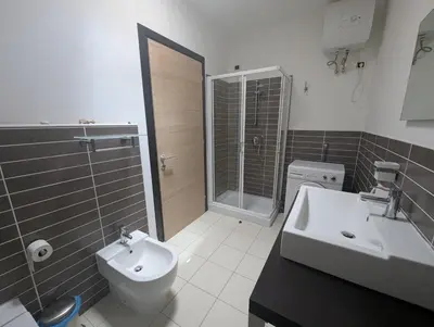 a bathroom with a toilet and a sink and a shower at Large Townhouse close to Beach in Sal Rei