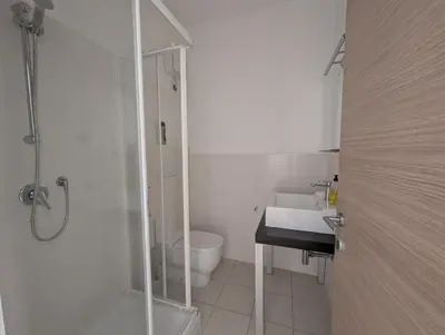 a bathroom with a shower and a toilet and a sink at Large Townhouse close to Beach in Sal Rei