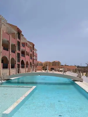a large swimming pool with a bridge over it at Large Townhouse close to Beach in Sal Rei