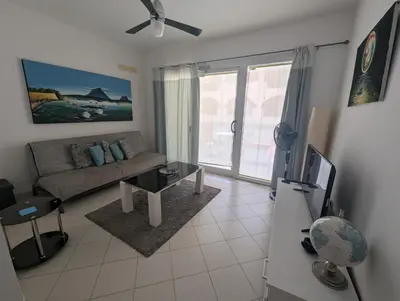 a living room with a couch and a tv at Large Townhouse close to Beach in Sal Rei