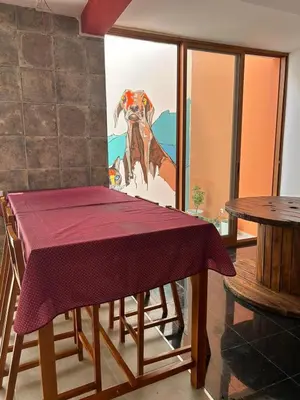 a dining room table with a purple table cloth on it at Villa PalMarina in Praia