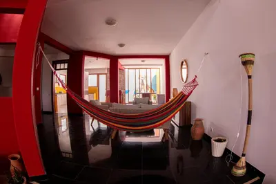 a hammock in the middle of a living room at Villa PalMarina in Praia