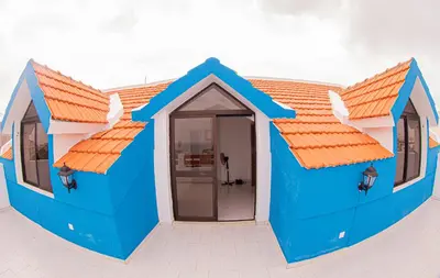 a house that is painted blue and has orange roofs at Villa PalMarina in Praia