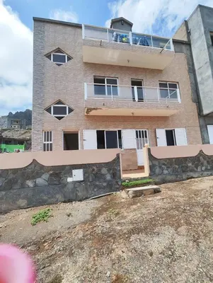 a brick building with a balcony on top of it at Casa Andrade Delgado - Rocha Grande in Ponta do Sol