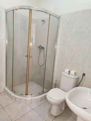a bathroom with a shower and a toilet and a sink at Casa Andrade Delgado - Rocha Grande in Ponta do Sol